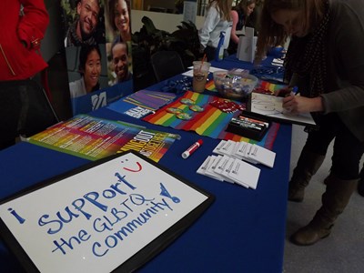 LGBTQ+ Resources table with sign stating "I support the GLBTQ community"