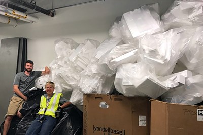 Sustainable Move-In coordinators pose with plastic foam that was collected