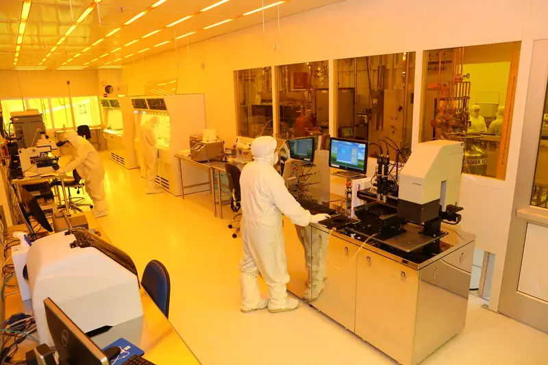 A worker in a clean suit in UMass Lowell's Nanofabrication Lab
