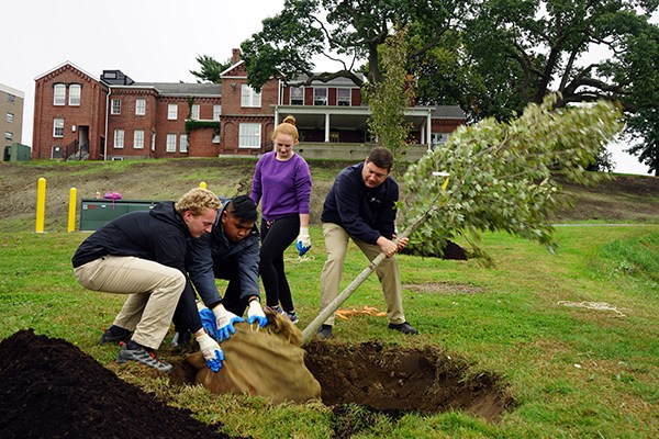 Students and staff plant a tree on South Campus