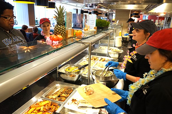 Students serve chicken at the South Campus Dining Hall