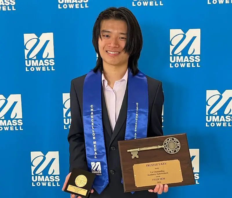 Mathematics Major, Tyler Moh, holds the Chancellor’s Medal and Trustees Key.