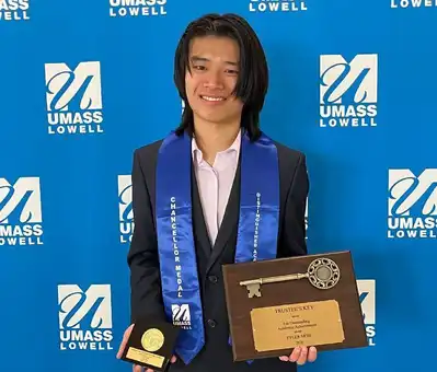 Mathematics Major, Tyler Moh, holds the Chancellor’s Medal and Trustees Key.