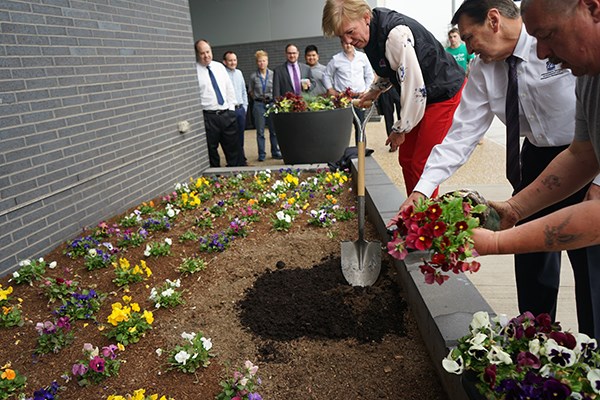 Joanne Yestramski helps plant flowers with the compost