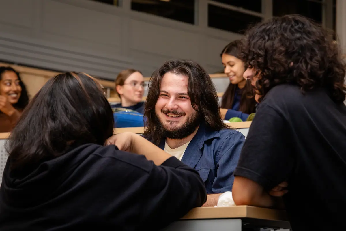 Three students talking and laughing.
