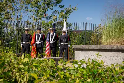 The Lowell Fire Guard stands at attention near "Unity," UMass Lowell's Sept. 11 memorial.