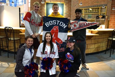UMass Lowell students pose with Red Sox (and Spinners) swag at Campus Rec before Game 1