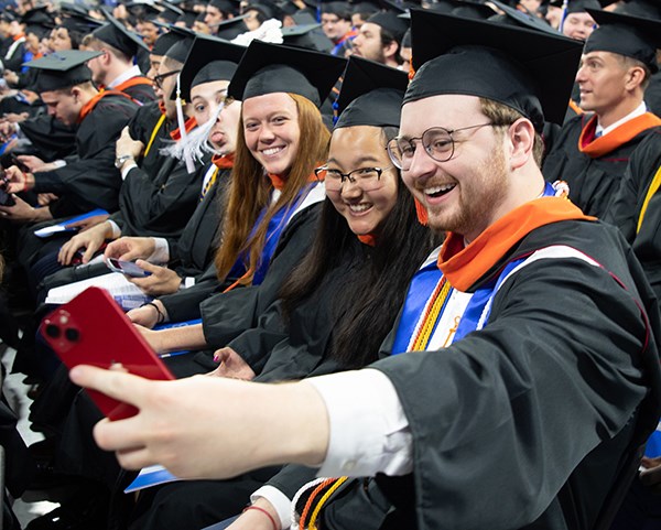 Class of 2023 members take selfies during Commencement exercises on Saturday, May 13.