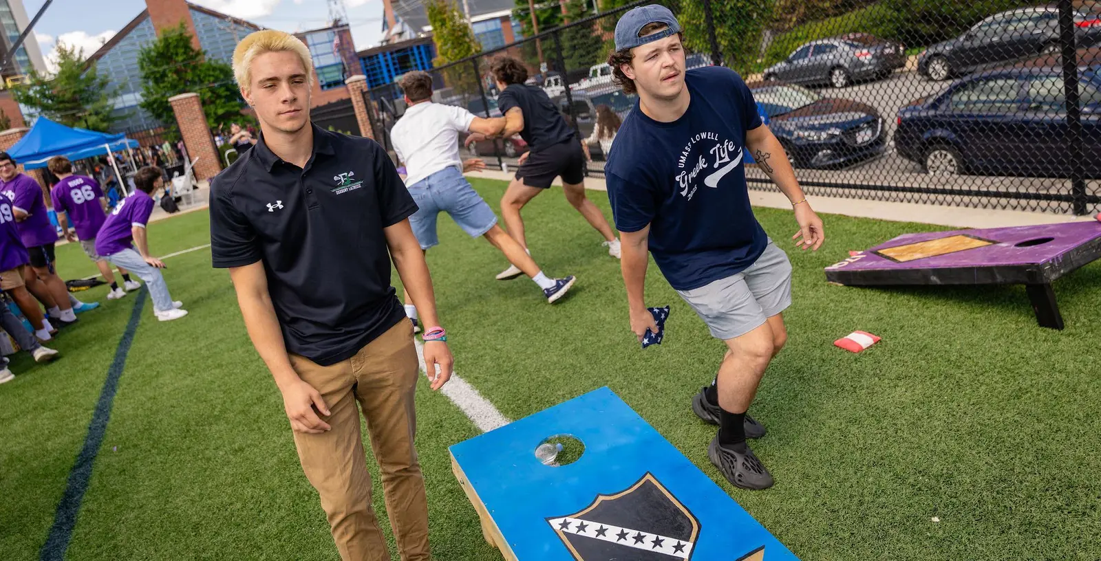 Two students play cornhole