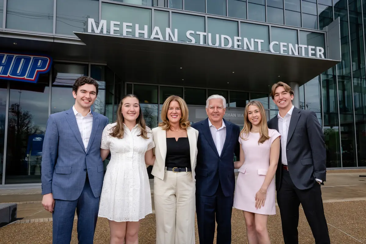 UMass President Marty Meehan stands in front of the newly renamed Meehan Student Center with his wife Jennifer and their four children