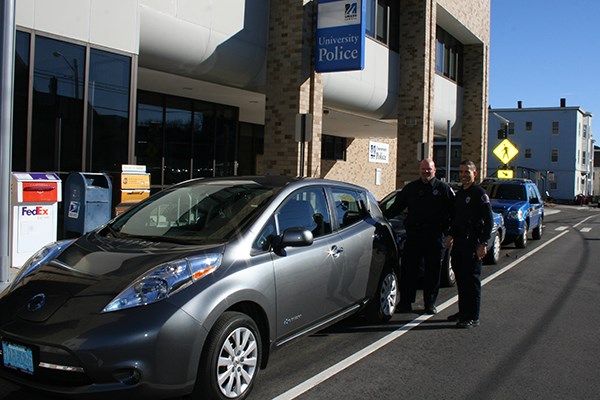 Officers Bill Emmons and Jeff Connors pose with the Nissan LEAF