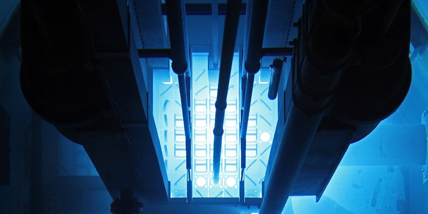 UMass Lowell's Reactor Core - pipes going down into a white blue light machinery.