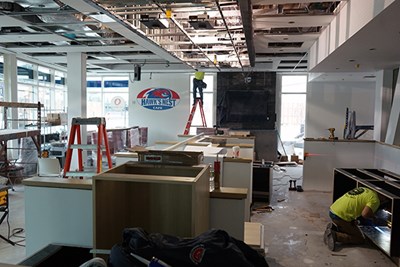Workers renovate the University Suites dining facility
