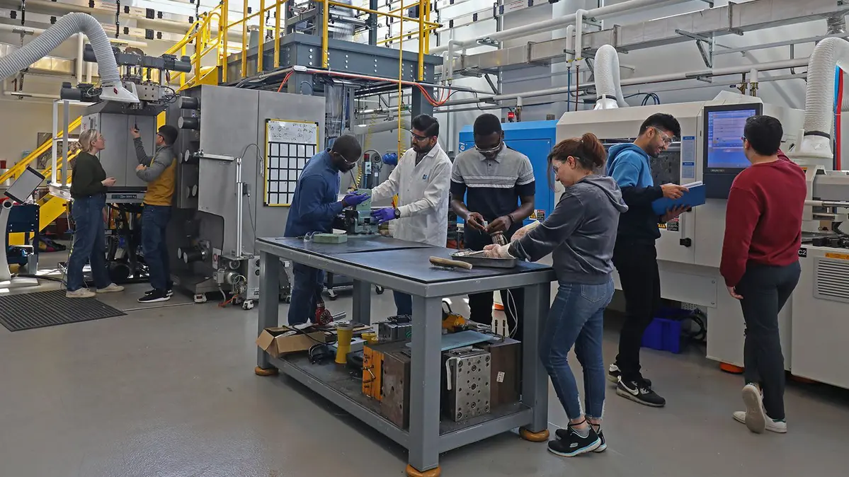 Students working in a Plastics Engineering lab at UMass Lowell.