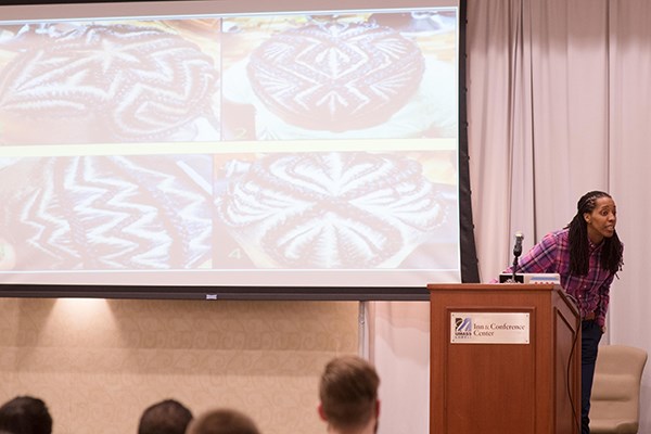 University of Georgia education professor Bettina Love talks at UMass Lowell about the links between contemporary African-American hair braiding and West African culture