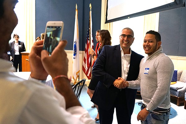 Vala Afshar poses for a photo with a student
