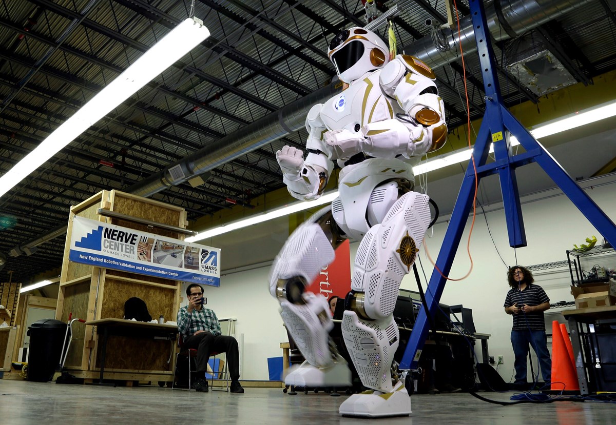 The Valkyrie Robot lifting a leg at the UMass Lowell NERVE Robotics Center.
