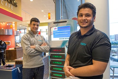 Veloxity co-founders Felipe Nascimento and Upkar Singh with their charging kiosk