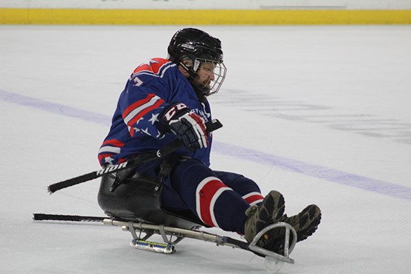 Student-veteran Ian Ramsdell demonstrates sled hockey at the Tsongas Center.