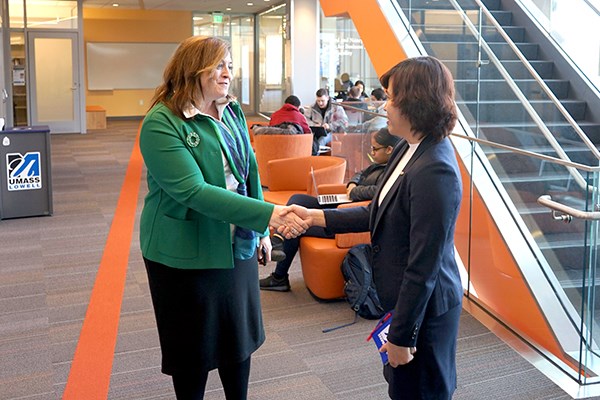 Dean Sandra Richtermeyer shakes hands with Tu Tran
