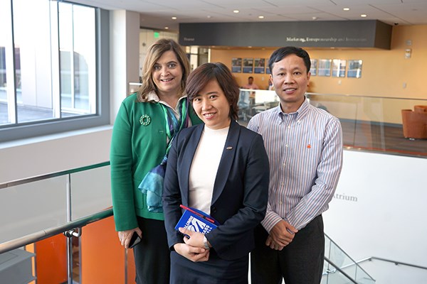 Sandra Richtermeyer, Tu Tran and Hieu Phan pose for a photo at the business school