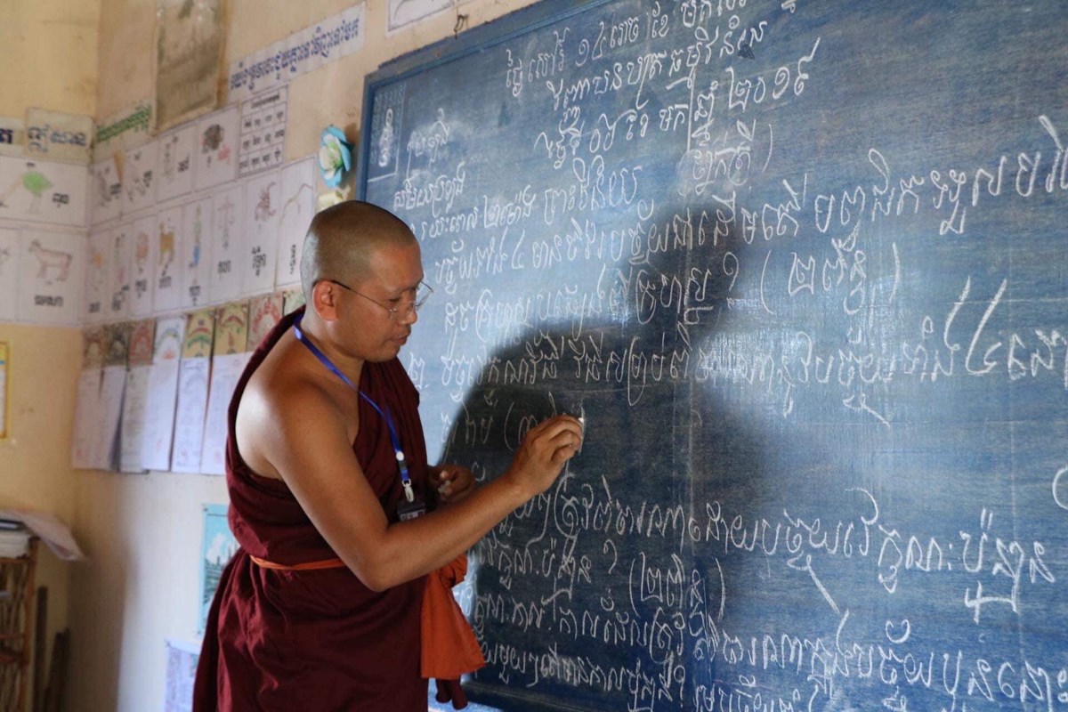 This photo taken in January 2019 shows Ven. Vouthy Phin, a Dhammavinaya exam coordinator, writing questions on the board at Bunrany Hun Sen Primary school, Takeo, Cambodia. Photo provided by Vouthy Phin.