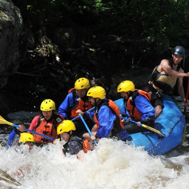 A group of participants rafting down a rapid.