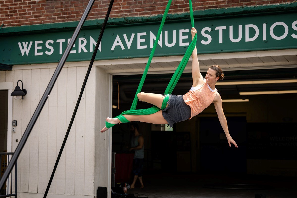 Performer floats in front of Western Ave. Studios in Lowell