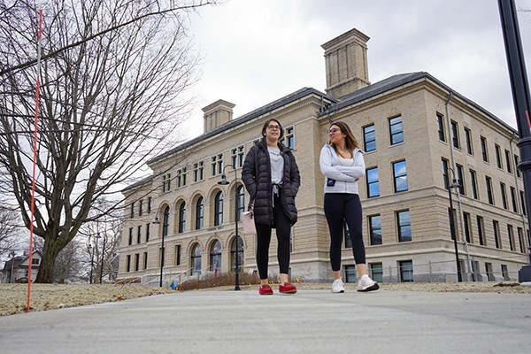 Two students walk in front of the renovated Coburn Hall