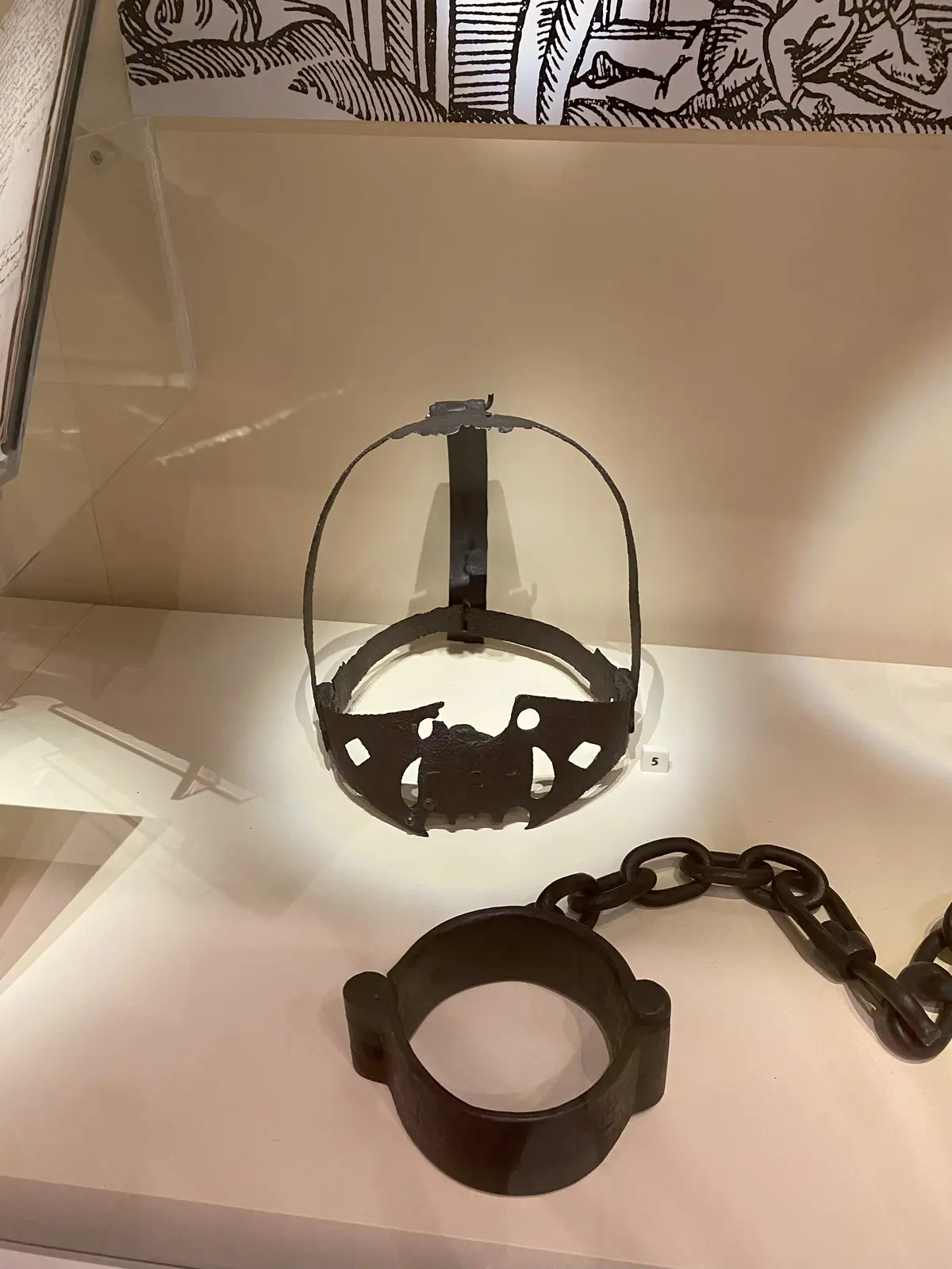 Scold's Bridle and wrist cuff on display.