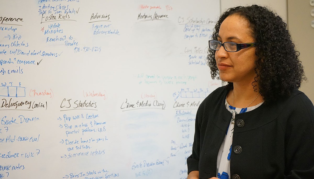 Yahayra Michel in front of a white board with words on it
