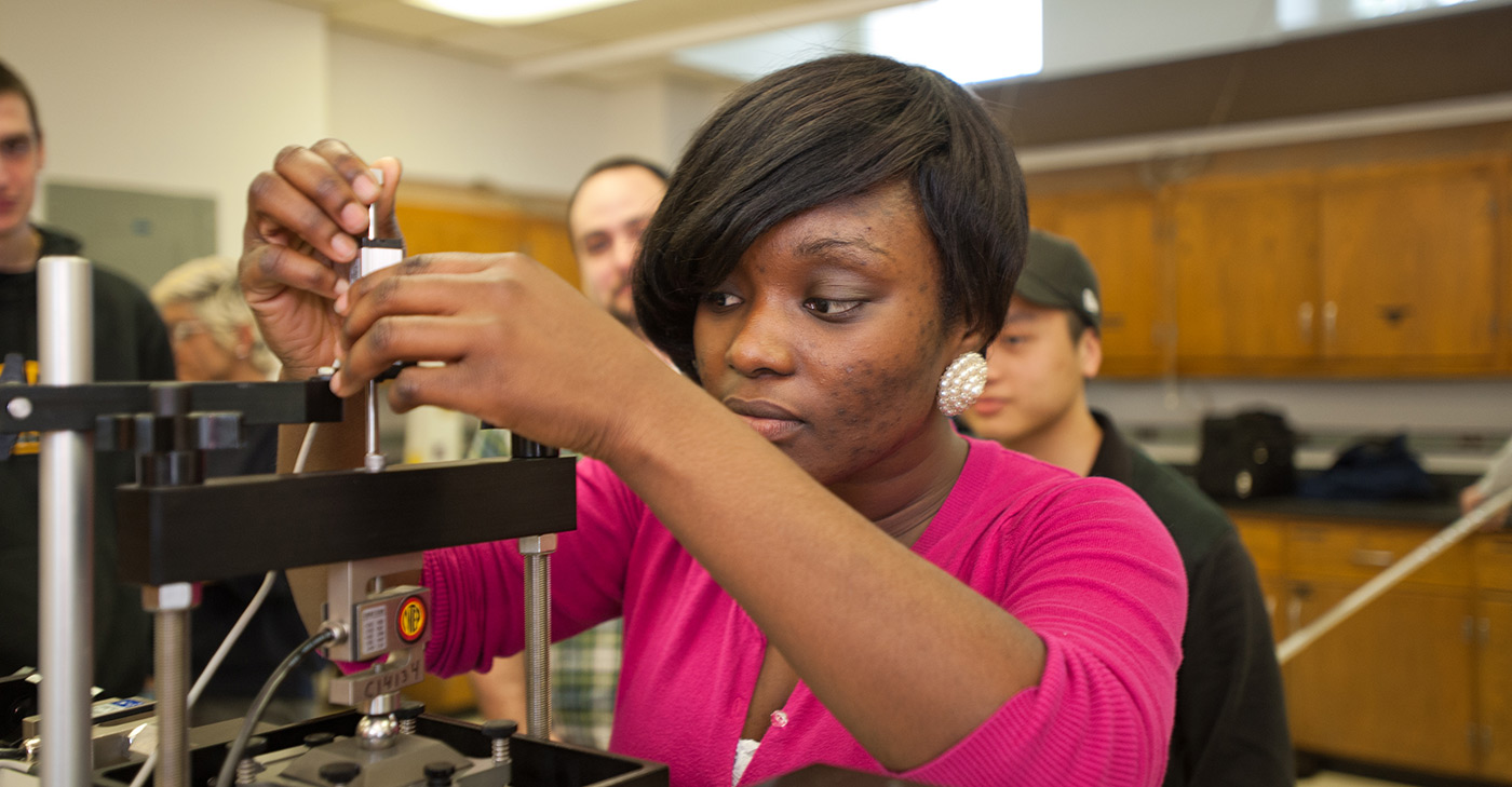 A Female African American UMass Lowell student working in a Civil & Environmental Engineering lab.