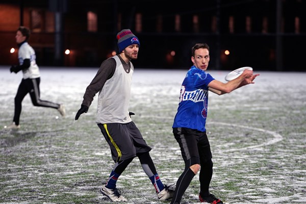 Two UMass Lowell students play ultimate frisbee on the new Campus Rec Complex on East Campus
