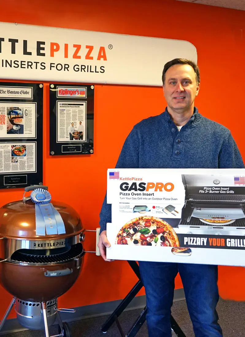 Al Contarino shows off a KettlePizza product at his showroom in North Andover