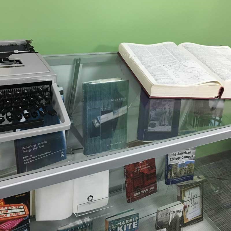 Museum display of writer artifacts including a typewriter and books