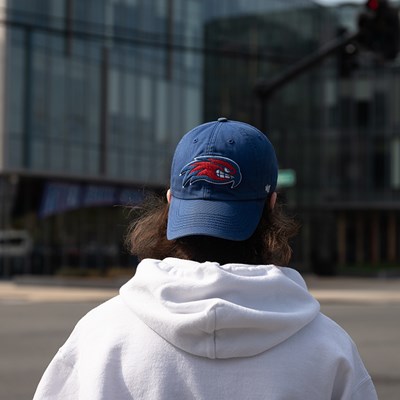Back of students head wearing baseball cap with rowdy on it