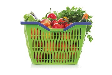 Green basket full of colorful vegetables