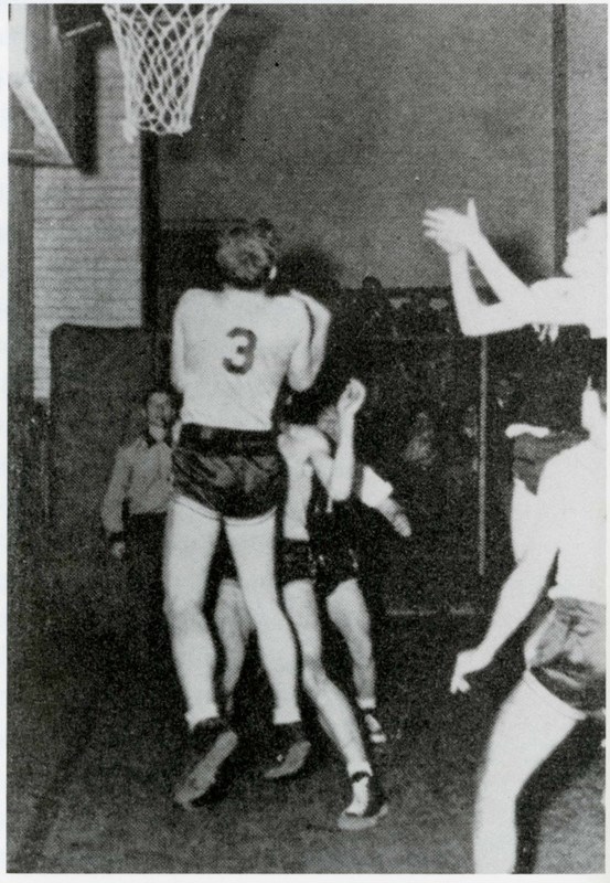 A men’s basketball player shoots during a game on the top floor of Southwick Hall in in 1948