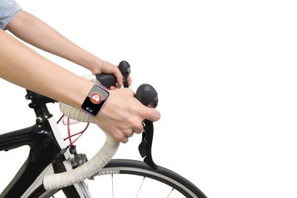 Closeup of person riding bike wearing smart watch