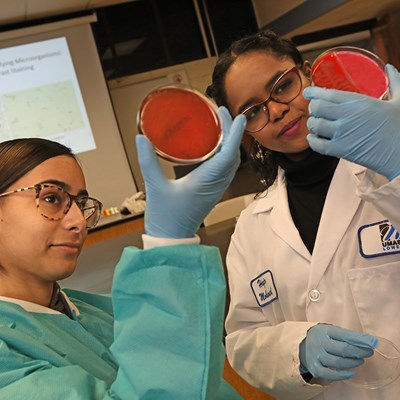 Two female students look at lab samples