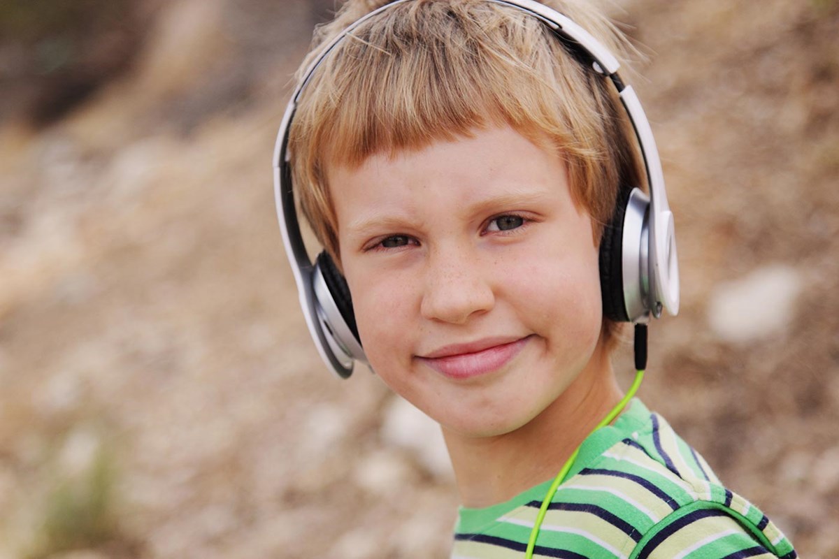 young boy wearing headphones