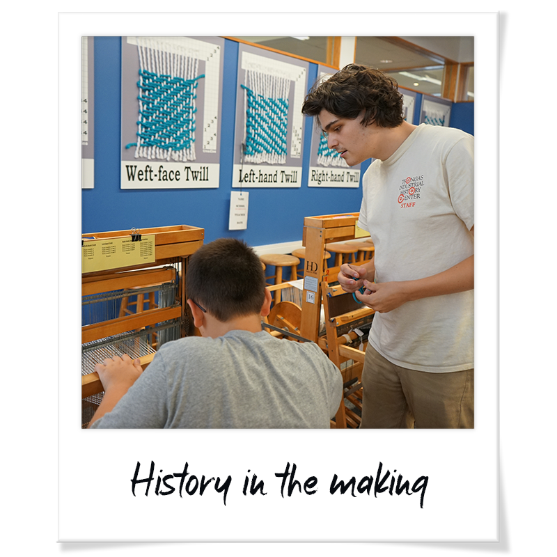 "Polaroid" photo of Bradley Sherwood teaching a student how to weave on a loom at a Tsongas Industrial History Center summer camp - handwriting on frame reads "History in the making"