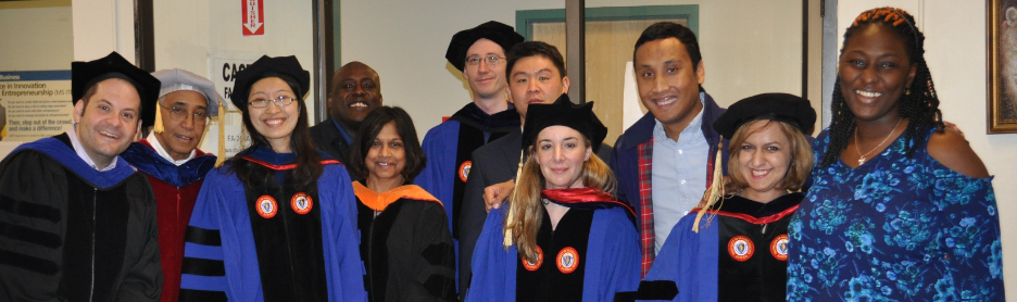 Group photo of Ph.D. graduates and faculty from commencement.