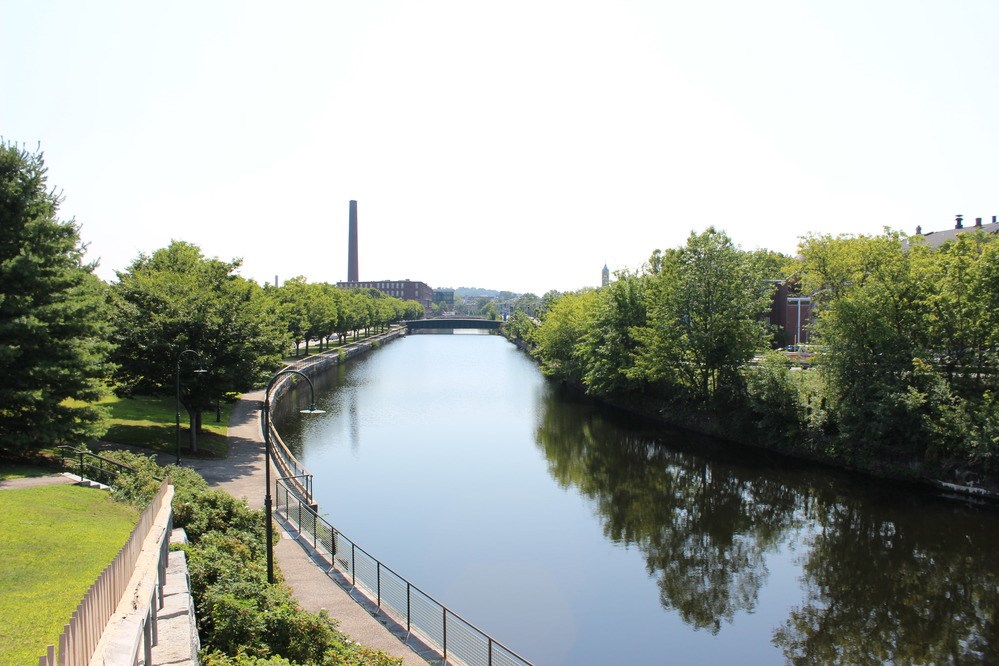 Canal with trees and smokestack