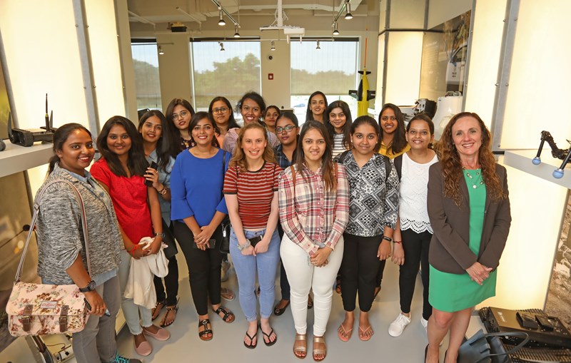 UML student ambassador Catherine de Groot with a group of students from M.O.P. Vaishnav College for Women in Chennai, India, who came to campus for an intensive summer business program