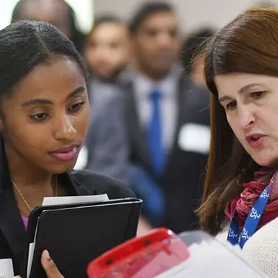 Two women look at a clipboard