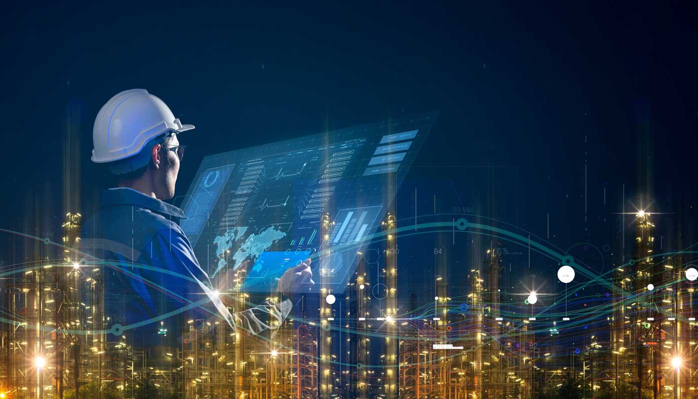 Engineer wearing a hard hat and looking at a smart screen with a smart industry background