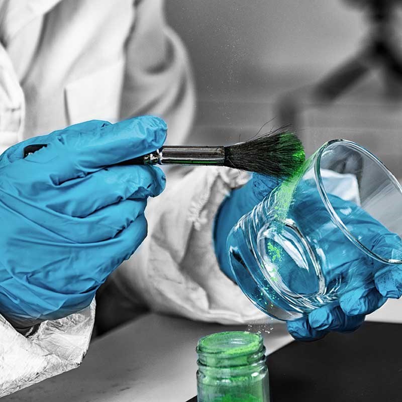Gloved hands brush across a drinking glass to identify fingerprints 