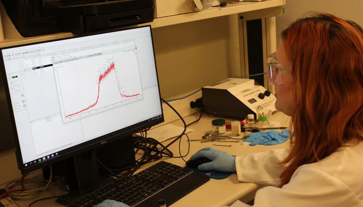 A person views data graphs in a UMass Lowell chemistry lab.