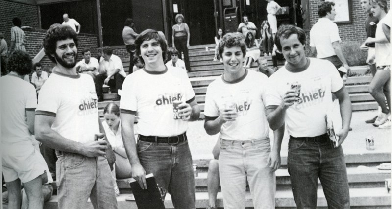 Four male students in matching Chiefs t-shirts